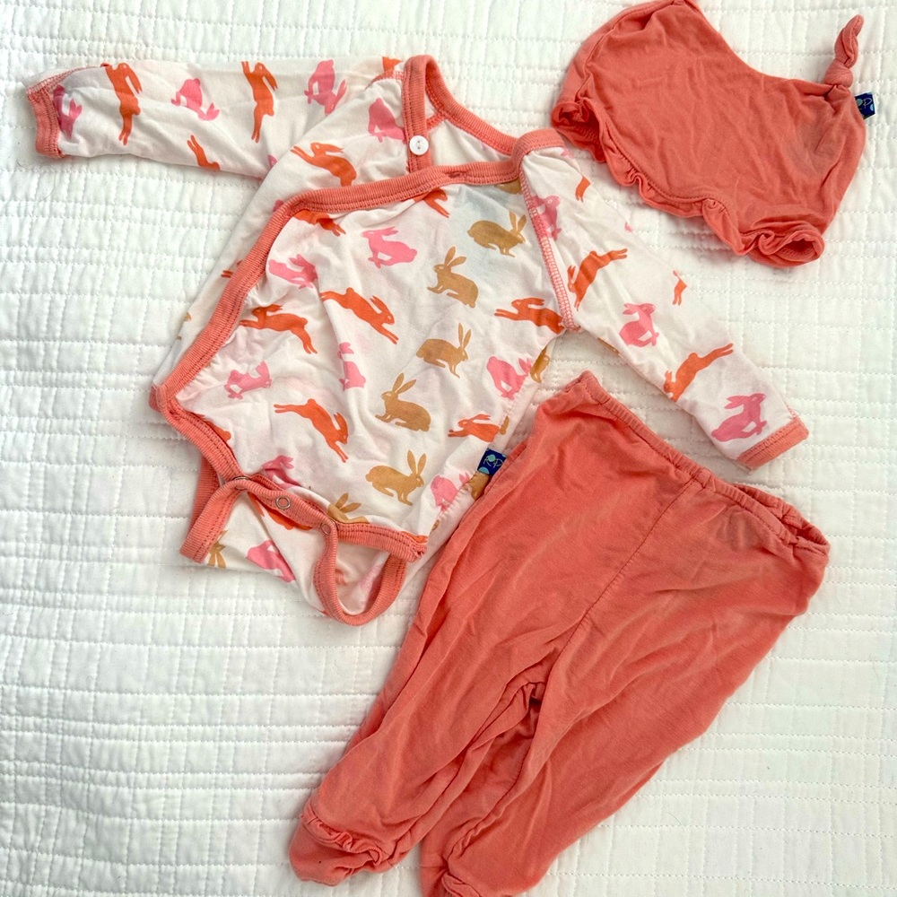Newborn kickee pants onesie with matching footed pants and hat.